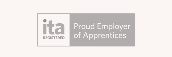 A grayscale sign reads "ita REGISTERED Proud Employer of Apprentices.