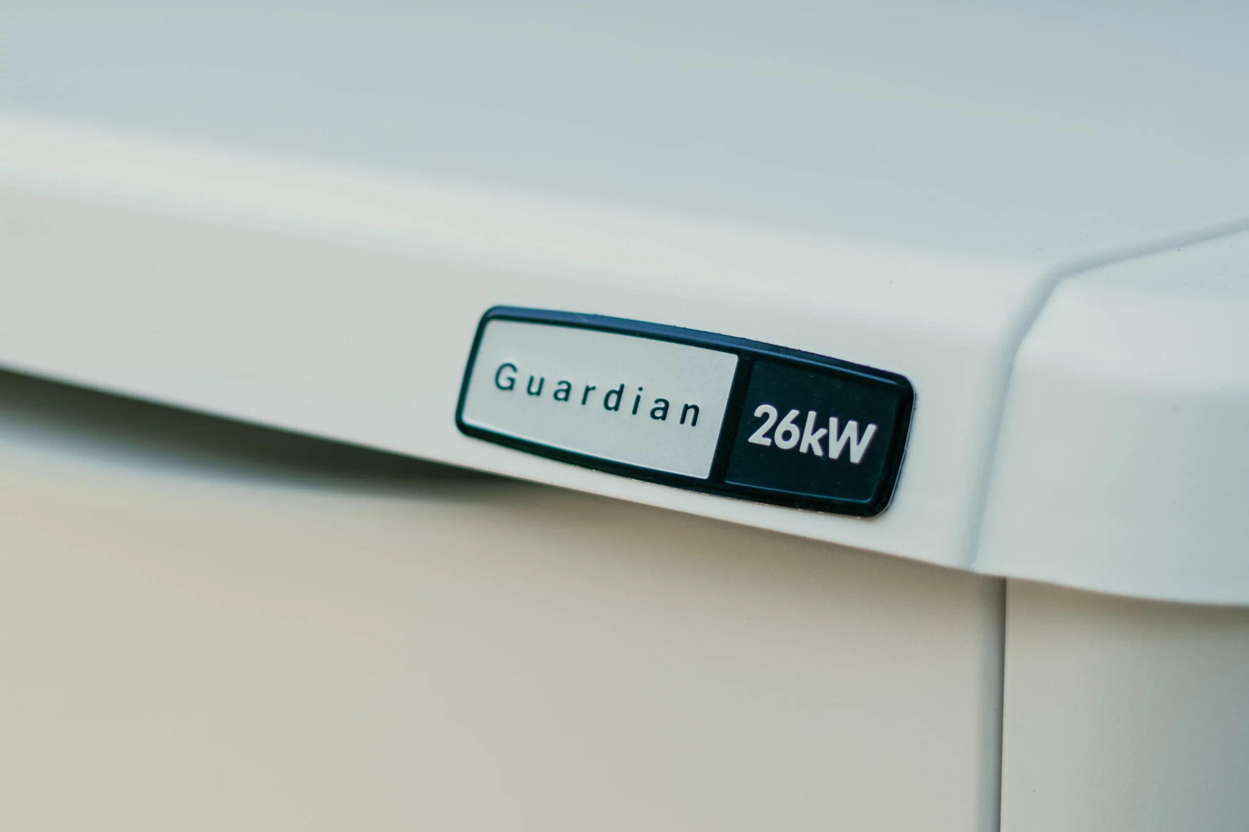 Close-up of a label on a white device that reads "Guardian 26kW.