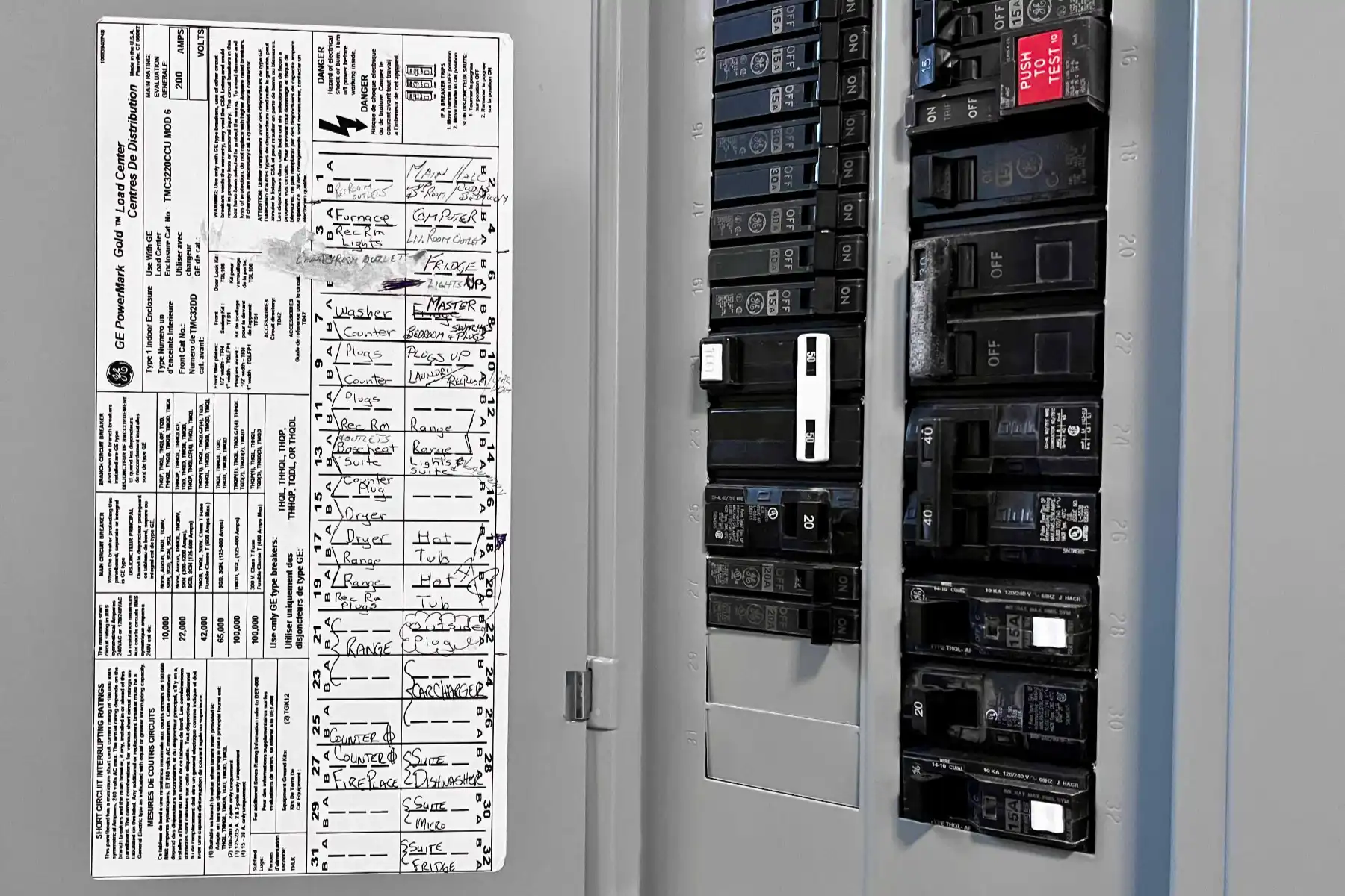 A labeled circuit breaker panel with handwritten descriptions for each circuit is visible on the inside of the panel door.